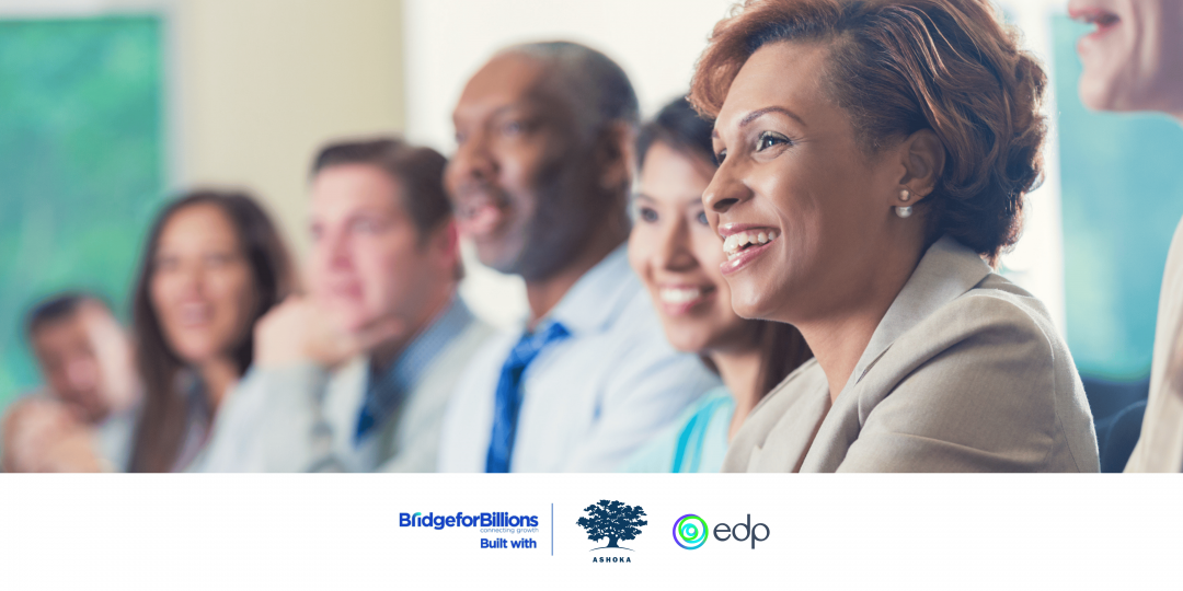 group of entrepreneurs seating smiling at a meeting